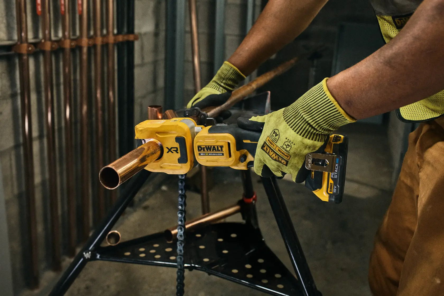 DEWALT Rohrwerkzeug im Einsatz. Fotografie. SKUs: DCE154N, DCE154N-XJ. Handschuhe getragen.