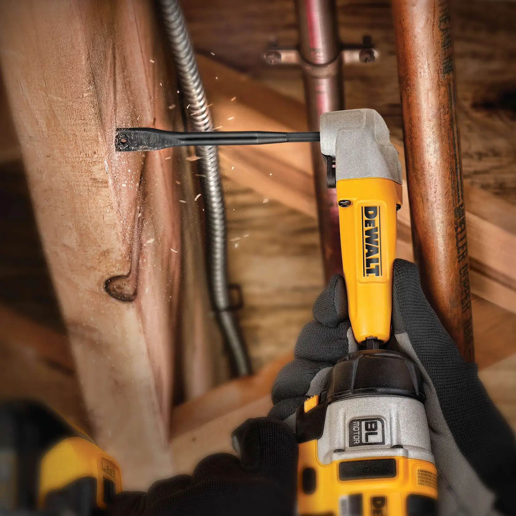 DEWALT drill with DT4776 bit drilling into wood near pipes, held by gloved hands.