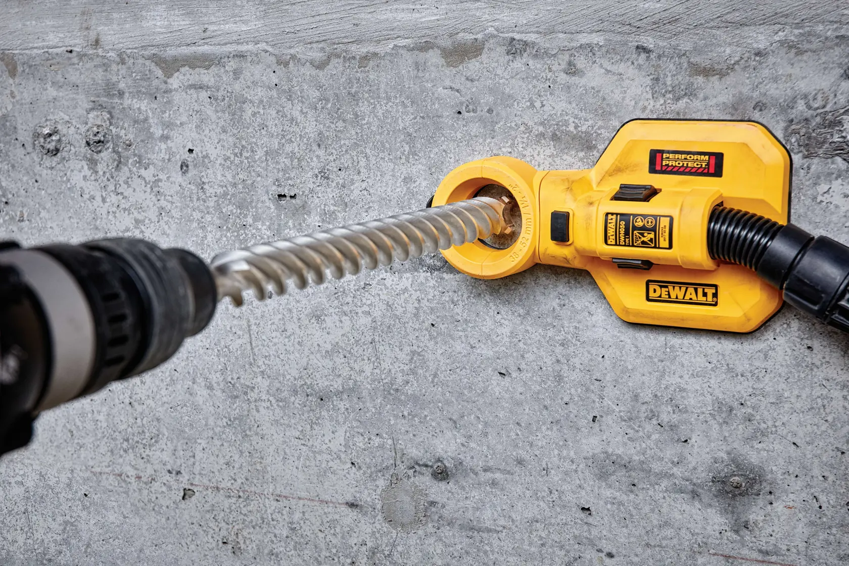Extractor de polvo DEWALT DT60845 acoplado a taladro para perforar concreto.